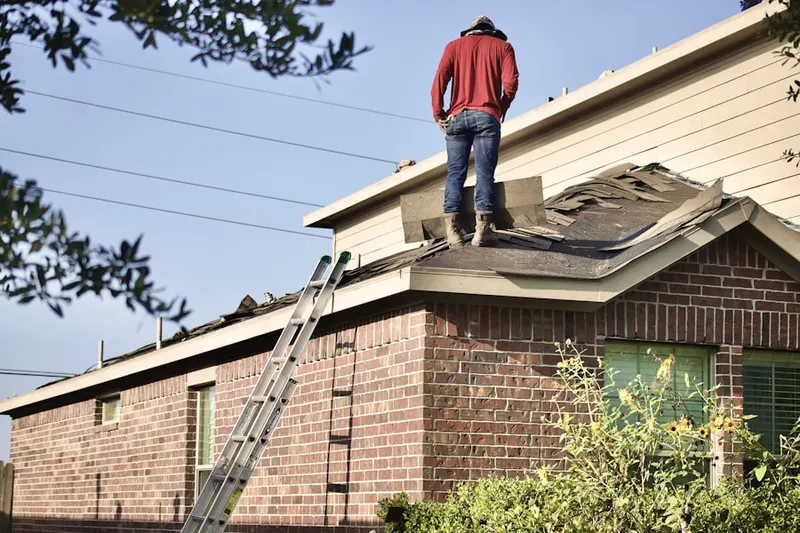 Professional roofer working on a residential roof in Memorial Heights